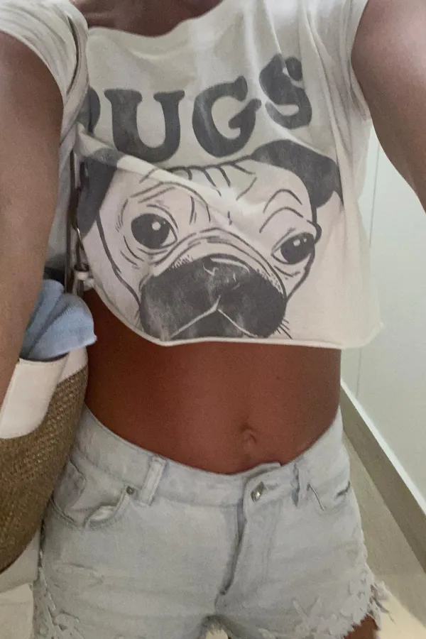 Molly taking a selfie in a pug croptop